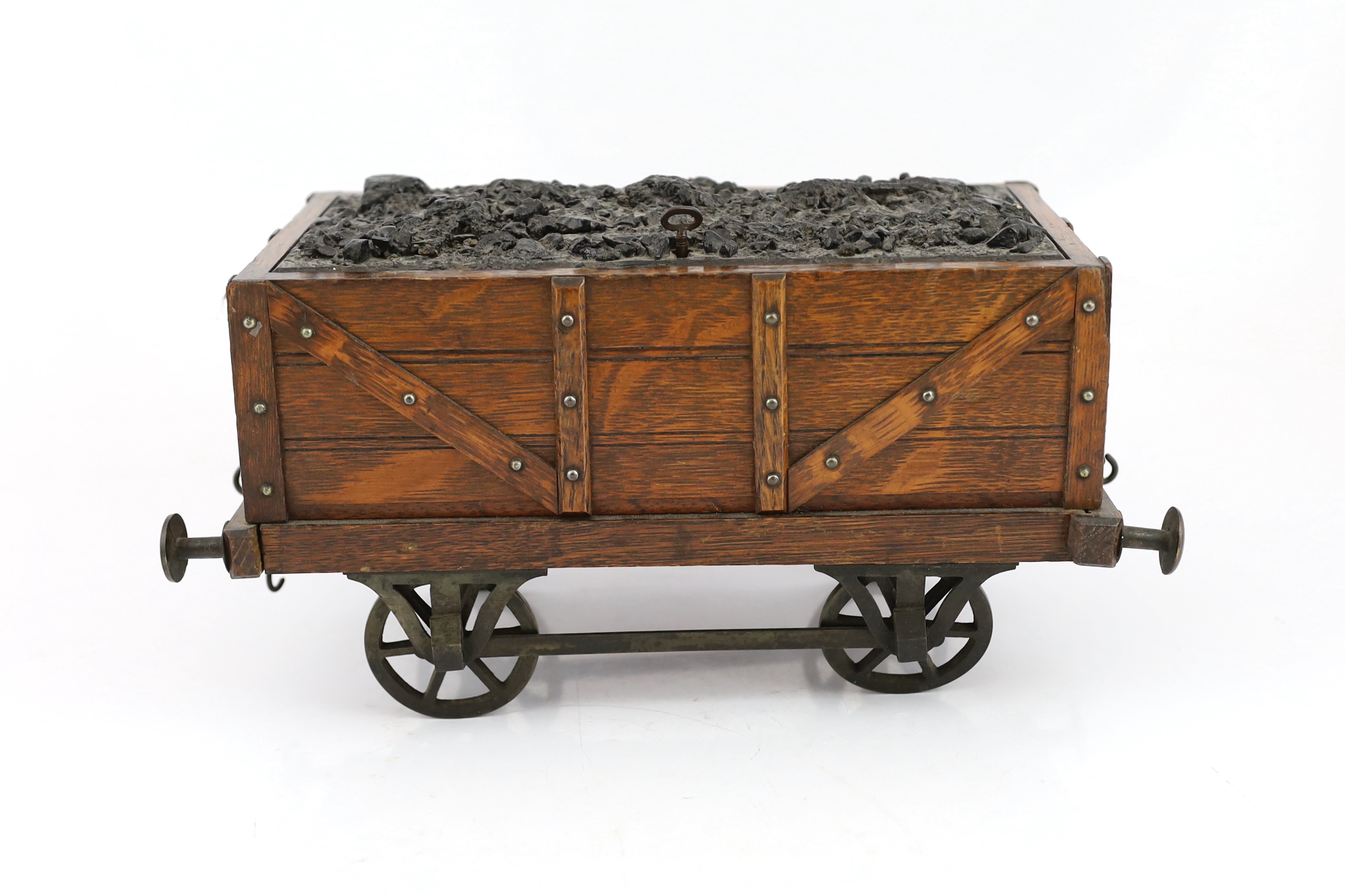 An Edwardian novelty oak smoker's compendium modelled as a railway tender, 34cm wide, 17cm deep, 17cm high